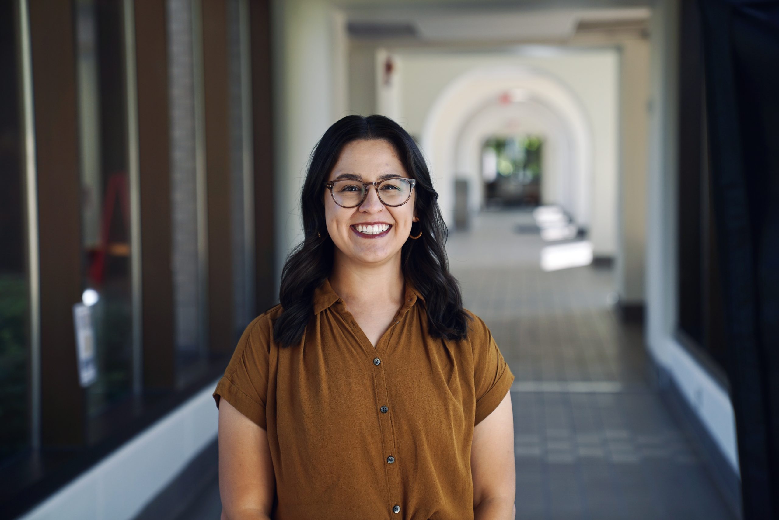 Kaela Bright, a woman with black hair in a brown shirt